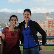 three students with a college campus in the background